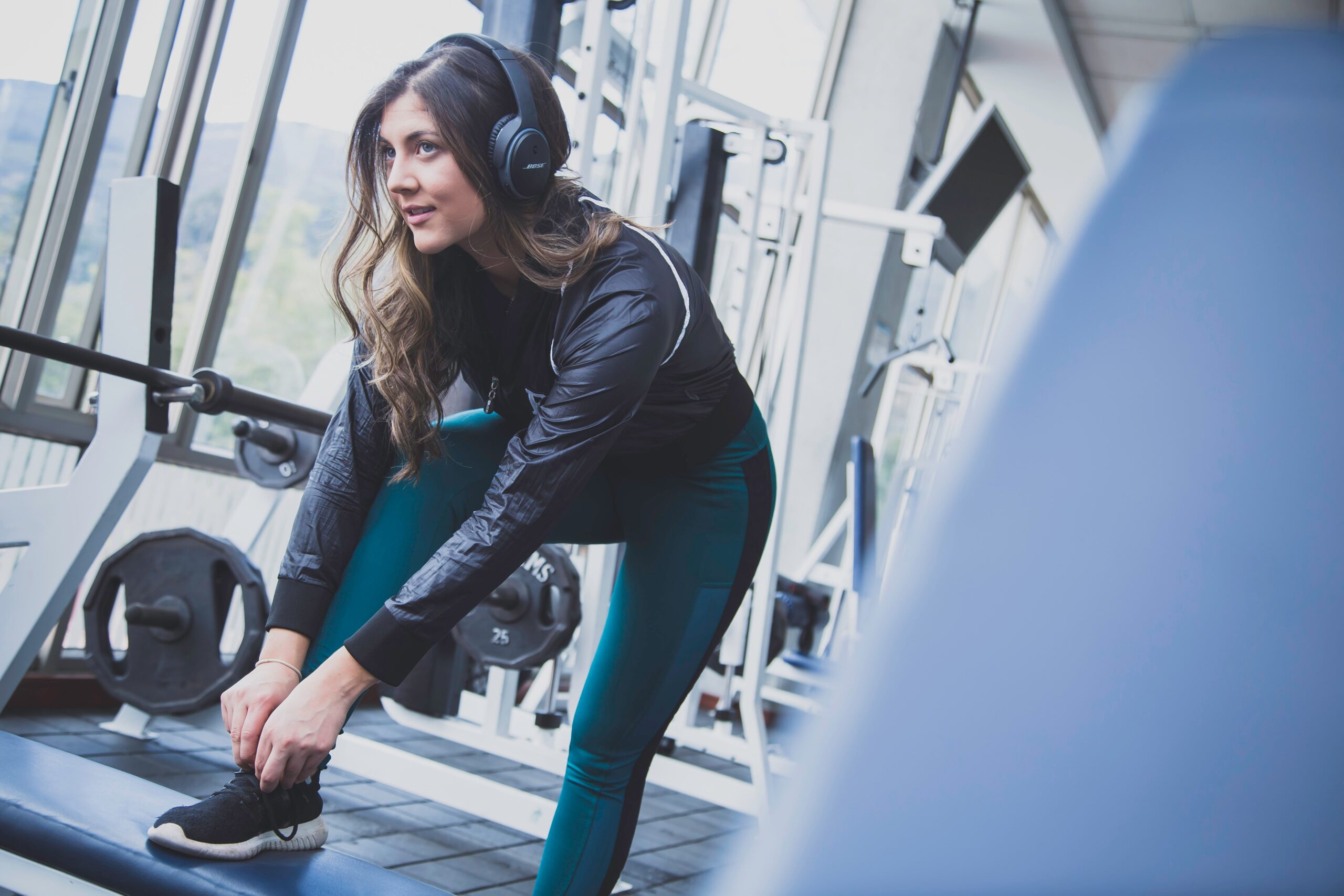 Girl exercising in gym with headphones